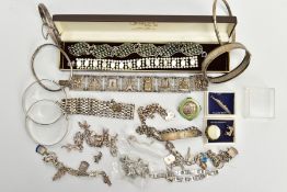 AN ASSORTMENT OF SILVER AND WHITE METAL JEWELLERY, to include three silver hinged bangles, a thin