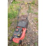A CHAMPION PETROL LAWNMOWER with grass box (engine pulls freely but not tested)