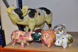 A COLLECTION OF FOUR CERAMIC AND RESIN PIGGY BANKS AND TWO OTHER PIG FIGURES, including a resin