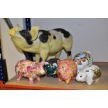 A COLLECTION OF FOUR CERAMIC AND RESIN PIGGY BANKS AND TWO OTHER PIG FIGURES, including a resin