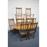 AN ERCOL OLD COLONIAL ELM CIRCULAR EXTENDING PEDASTAL DINING TABLE, with one fold out leaf, diameter