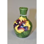 A SMALL MOORCROFT POTTERY BOTTLE VASE, decorated with tubelined pink/purple and yellow Hibiscus