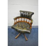 A GREEN LEATHER BUTTONED SWIVEL OFFICE CHAIR (condition - slight wear to frame)