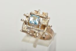 A 9CT GOLD ABSTRACT DRESS RING, a white gold squared design centrally set with a single square cut