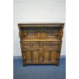 A MID CENTURY REPRODUCTION SOLID CARVED OAK COURT CUPBOARD, top with two cupboard doors, with twin