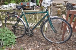 A GREEN RALEIGH PIONEER GENTLEMANS BICYCLE, with a 21 frame, shimano gears and a rear luggage rack