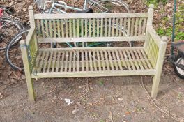 A WOODEN SLATTED GARDEN BENCH, width 136cm x depth 57cm