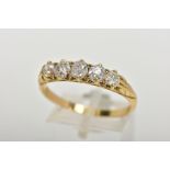 A YELLOW METAL FIVE STONE DIAMOND RING, designed with a row of five old cut diamonds, estimated