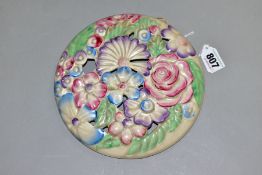 A CLARICE CLIFF WILKINSON LTD CIRCULAR BOUQUET WALL PLAQUE, relief moulded with pastel colour