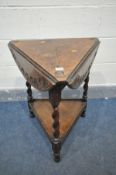 AN EARLY 20TH CENTURY OAK TRIANGULAR OCCASIONAL TABLE with triple drop leaves, open diameter 65cm