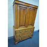 A 19TH CENTURY AND LATER OAK TWO DOOR CUPBOARD ON CHEST, with fitted cornice, two linenfold panelled