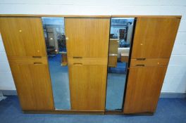 A UNIFLEX FIVE PIECE TEAK BEDROOM SUITE, comprising of a double door wardrobe with a central mirror,