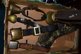 FIVE VINTAGE COW BELLS, comprising a brass bell by Barinotto Chiantel & Cie with leather collar,