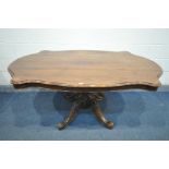 A LATE VICTORIAN WALNUT TILT TOP LOO TABLE, with a wavy edge, with a rosewood border, on a single