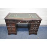 AN EARLY 20TH CENTURY MAHOGANY PEDASTAL DESK, with green tooled leather inlay, and an assortment