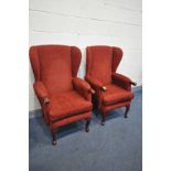 A PAIR OF 'HLS' RED UPHOLSTERED WINGBACK ARMCHAIRS, on cabriole legs