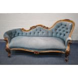 A VICTORIAN WALNUT CHAISE LONGUE, with pale blue upholstered button back, within a foliate and