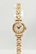 A 9CT GOLD LADIES WRISTWATCH, a white dial, wearing to the name, gold tone baton markers and