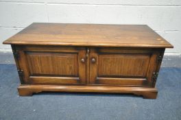 A REPRODUCTION OAK TWO DOOR TV CABINET, width 108cm x depth 50cm x height 45cm