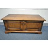 A REPRODUCTION OAK TWO DOOR TV CABINET, width 108cm x depth 50cm x height 45cm