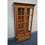 A CHERRYWOOD TWO DOOR DISPLAY CABINET, enclosing three glass shelves, width 91cm x depth 41cm x