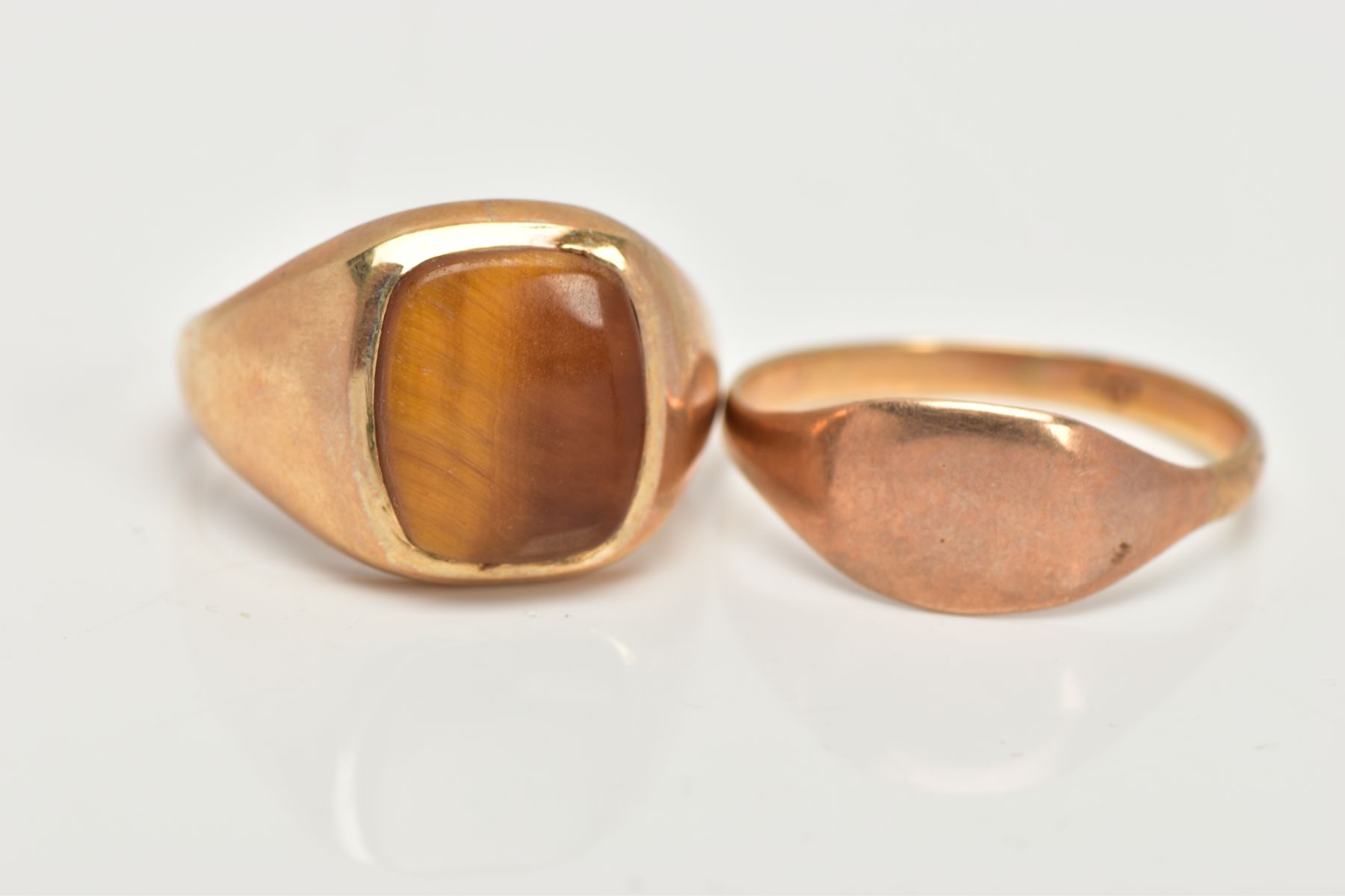 A 9CT GOLD TIGERS EYE SIGNET AND YELLOW METAL SIGNET, a large signet ring set with a squared