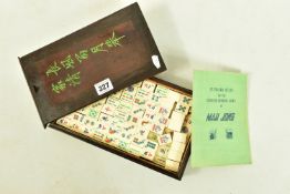 A STAINED HARD WOOD MAH JONG SET, the box finished with green painted Chinese writing, numbered to