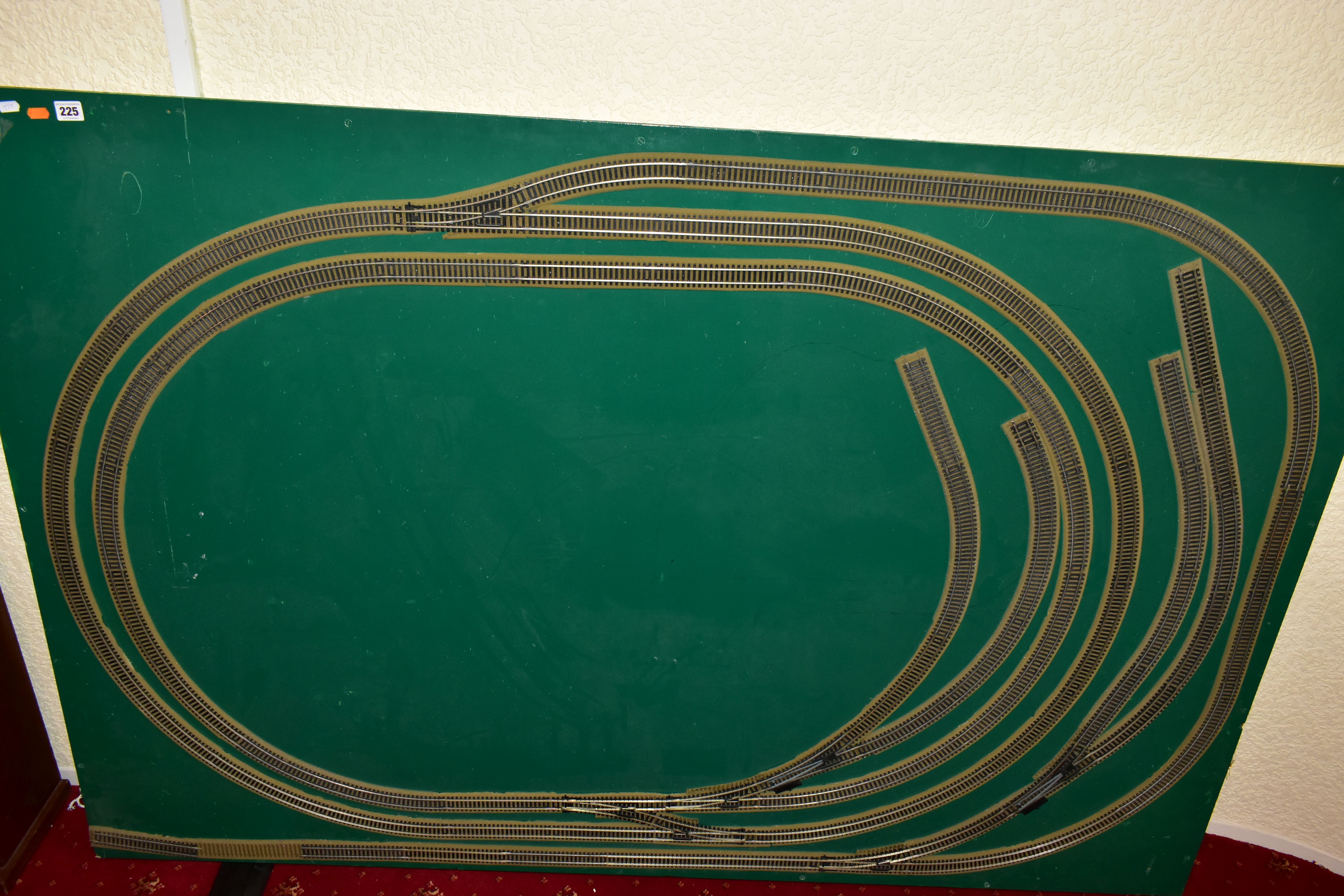 A OO GAUGE MODEL RAILWAY LAYOUT, double oval of track, with a long branch line and four sidings (two