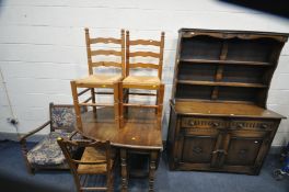 AN OAK DRESSER, with a two tier plate rack, base with two drawers above two cupboard doors with