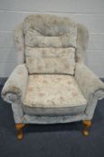 A FLORAL UPHOLSTERED WING BACK ARMCHAIR