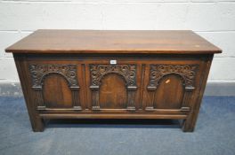 A REPRODUCTION OAK COFFER, the three panels with triple decorated arches, width 122cm x depth 50cm x