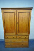 A VICTORIAN STAINED PINE HOUSEKEEPERS CUPBOARD, the double panelled cupboard doors enclosing three