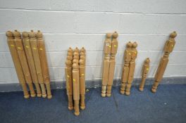 A LARGE QUANTITY OF PINE TURNED SPINDLES, various shapes and sizes, possibly for a bed (24)