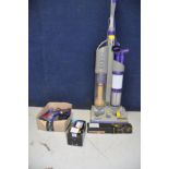 A DYSON DC03 UPRIGHT VACUUM CLEANER , spare brush bar and filter and three attachments for a more