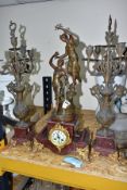 AN EARLY 20TH CENTURY BRONZED SPELTER AND ROUGE MARBLE CLOCK GARNITURE, the clock with figural