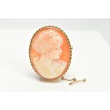A 9CT GOLD CAMEO BROOCH, an oval shell cameo depicting a lady in profile, mounted in yellow gold