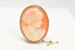 A 9CT GOLD CAMEO BROOCH, an oval shell cameo depicting a lady in profile, mounted in yellow gold