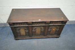 A REPRODUCTION OAK COFFER, the three panels with decorated arches, width 118cm x 49cm x height 62cm