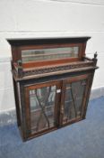 A MAHOGANY HANGING TWO DOOR CABINET, blind fretwork detail, with bevelled glass panels, enclosing
