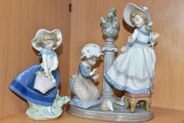 A LLADRO FIGURE GROUP AND A LLADRO FIGURE, comprising A Stitch In Time, no.5344, sculpted by