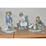 A LLADRO FIGURE AND TWO NAO FIGURES, comprising a Lladro 'Food for Ducks, no.4849, sculpted by