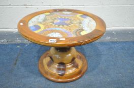 AN AFRICAN HARDWOOD CIRCULAR BUTTERFLY TABLE, the top with lepidoptery display, on a turned
