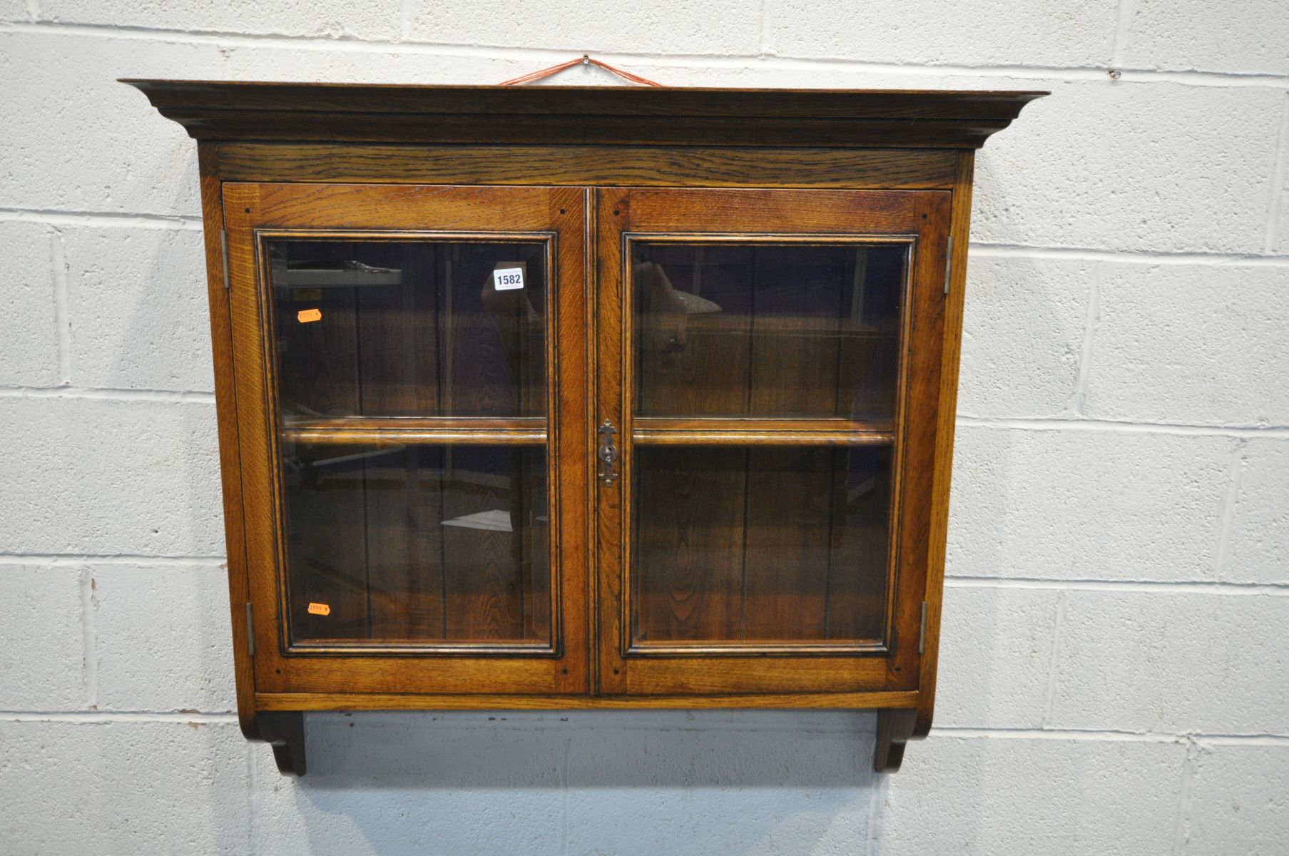 A REPRODUCTION OAK TWO DOOR GLAZED HANGING CABINET, with a single shelf, width 97cm x depth 24cm x