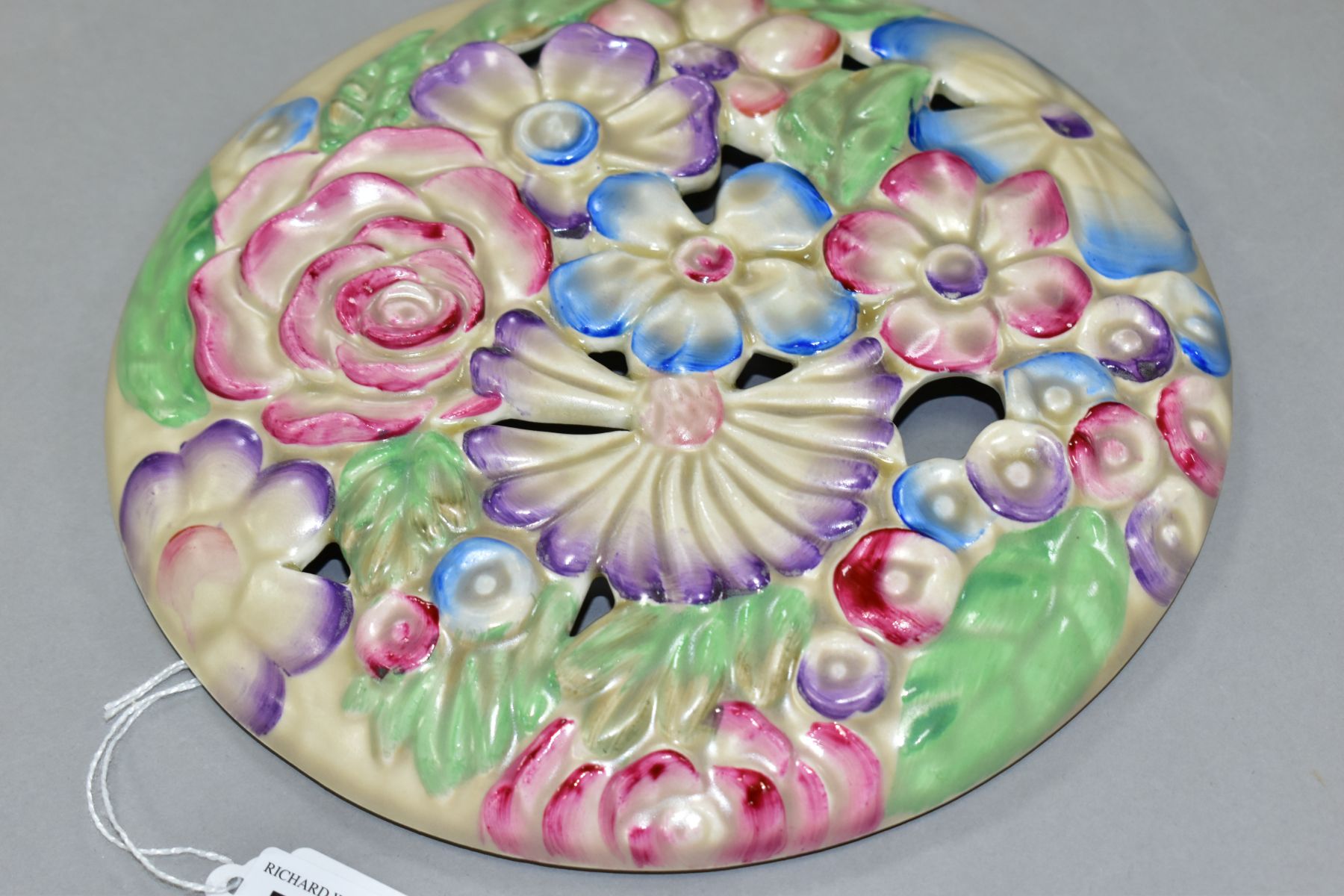 A CLARICE CLIFF WILKINSON LTD CIRCULAR BOUQUET WALL PLAQUE, relief moulded with pastel colour - Image 3 of 4
