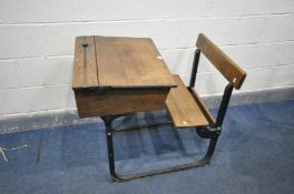 A VICTORIAN OAK SCHOOL DESK, with a hinged lid, on a cast iron frame, and a fold up seat, width 57cm