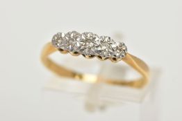 A YELLOW METAL DIAMOND RING, designed with a row of five illusion set single cut diamonds, pinched