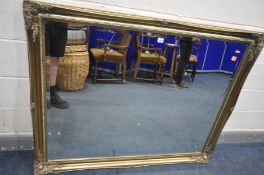 A LARGE RECTANGULAR GILT WOOD BEVELLED EDGE WALL MIRROR, with foliate design, width 132cm x height
