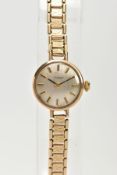 A 9CT GOLD TISSOT LADIES WRISTWATCH, a hand wound movement, round champagne coloured dial signed '