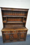 A REPRODUCTION OAK DRESSER, top plate rack with two shelves, two pigeon holes and two small drawers,