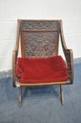 A LATE 19TH/EARLY 20TH CENTURY OAK GOTHIC REVIVAL GLASTONBURY CHAIR, with panelled back and seat,